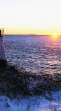 Scaricare immagine Lighthouses, Sea, Landscape, Snow, Sunset, Winter sul telefono gratis.